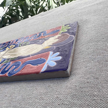 Close-Up of Male Nude Painted on Tile Place on Grey Fabric in a Garden