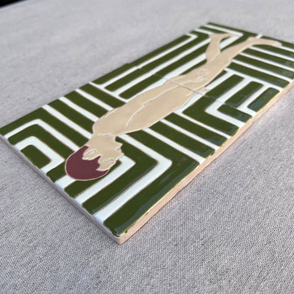 close-up of tile diptych showing male nude against and a green and white patterned background