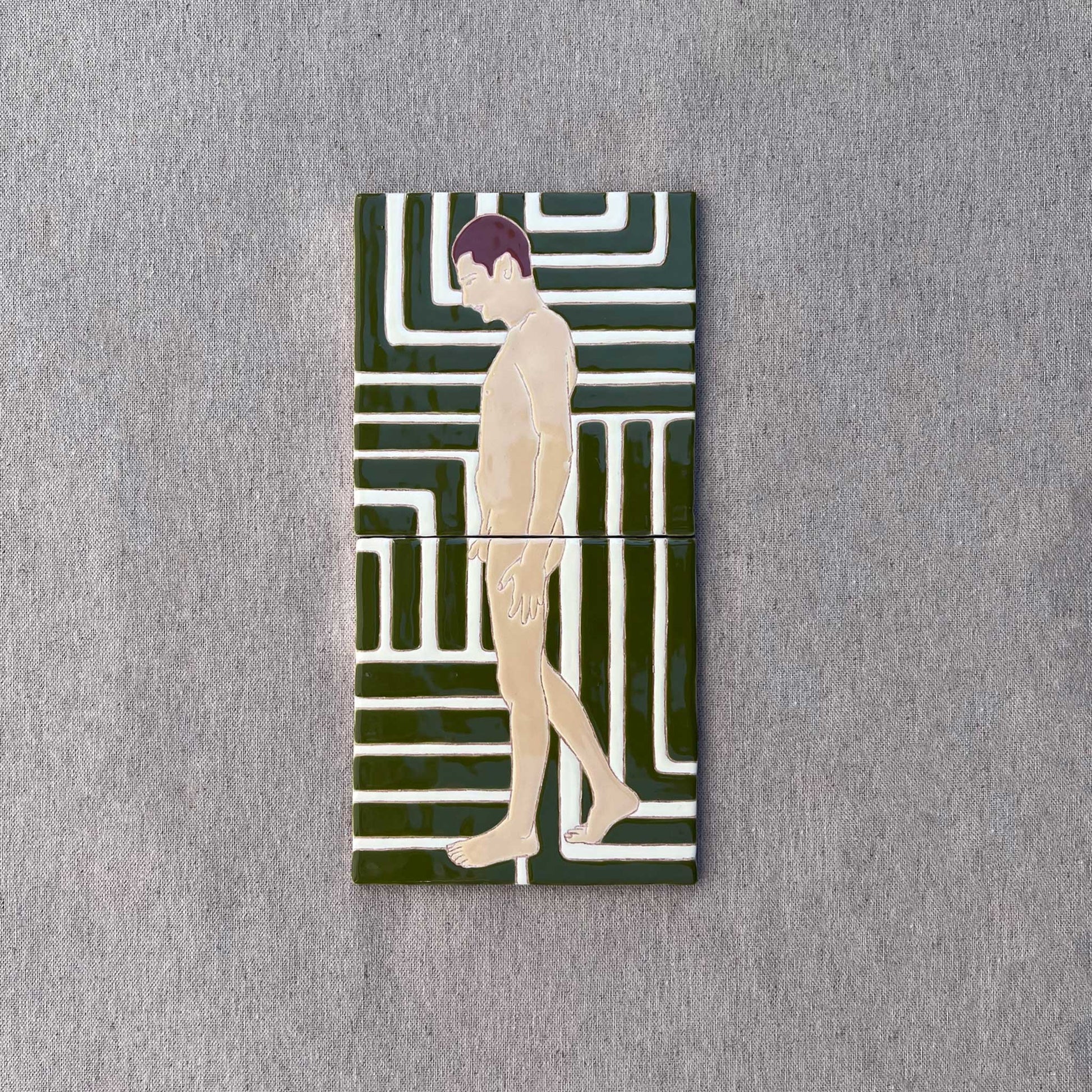 Tile diptych on grey background showing a pensive male nude against a patterned green and white background